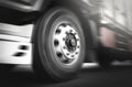 Front of a Truck Wheels Spininng, Speed Motion Blur Driving on The Road. Industry Road Freight by Truck. Logistics Transportation Royalty Free Stock Photo