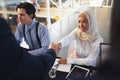 Business people shaking hands with each other while checking in at registration table Royalty Free Stock Photo