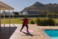 Senior woman performing stretching exercise in the backyard of home Royalty Free Stock Photo