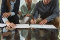 Active senior couple signing an agreement with real estate agent over documents in living room Royalty Free Stock Photo