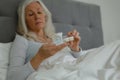 Active senior woman taking medicine in bedroom Royalty Free Stock Photo