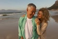 Active senior couple embracing each other on the beach Royalty Free Stock Photo