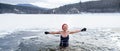 Front view of active senior woman in swimsuit outdoors in water in winter, cold therapy concept. Royalty Free Stock Photo