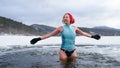 Front view of active senior woman in swimsuit outdoors in water in winter, cold therapy concept. Royalty Free Stock Photo