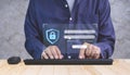 Adult man using computer keyboard with cybersecurity, login and user`s personal encryption icon on modern virtual
