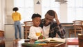 African American father helping his son with homework at table Royalty Free Stock Photo