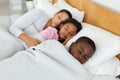 Mother and children sleeping together in bed in bedroom Royalty Free Stock Photo