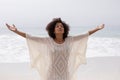 Woman standing with arms outstretched on the beach Royalty Free Stock Photo