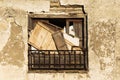 Front view of and aged and stained window with boards Royalty Free Stock Photo