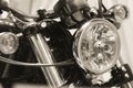 Front view of American heavy vintage motorcycle of a famous brand with wheel and headlight on showcase Royalty Free Stock Photo