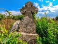 Front view of the ancient stone cross in an abandoned cemetery. Ancient monuments. Medieval architecture Royalty Free Stock Photo
