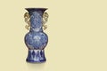 front view antique large blue and gold ceramic vase on yellow background, object, decor, fashion, gift, home, house, copy space Royalty Free Stock Photo