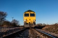 Front view of an approaching freight locomotive on railway tracks