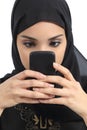 Front view of an arab woman addicted to the smart phone