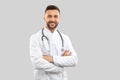 Smiling doctor with strethoscope isolated on grey. Royalty Free Stock Photo