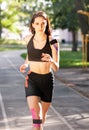 Athlete with kinesiological taping running outdoors.