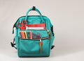 Front view  of backpack with school supplies on white  background with copy space Royalty Free Stock Photo