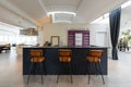 Front view with bar counter and three orange leather stools. Elegant interior Royalty Free Stock Photo