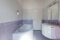 Front view bathroom with bathtub, sink and toilet. White wall