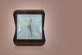 Front view, beautiful antique white and gold square alarm clock in a brown rectangular leather box on brown background, gift, old Royalty Free Stock Photo