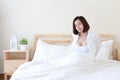 Front view beautiful and healthy young asian woman wake up in the morning, she stretching after wake up in the morning on white be Royalty Free Stock Photo