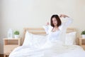 Front view beautiful and healthy young asian woman wake up in the morning, she stretching after wake up in the morning on white Royalty Free Stock Photo