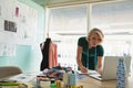 Female fashion designer using laptop at desk Royalty Free Stock Photo