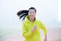 Front view of a beautiful sportswoman running towards camera