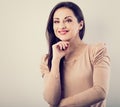 Front view of beautiful thinking woman with natural makeup looking with hand