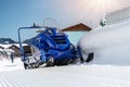 Front view big modern snow mobile scooter atv alpine mountain reosrt against sunny sky on cold snowy winter day Royalty Free Stock Photo