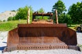 Front view of big rusty bucket of old huge heavy crawler bulldozer, abandoned vintage dozer