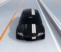 Front view of black electric sports car on the highway