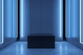 Front view on black empty podium and blank wall in abstract blue dark room interior with concrete floor and neon light, mockup. Royalty Free Stock Photo