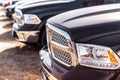 Front view of a black pickup truck in a row on a sunny day.