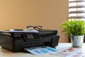 Front view of a black printer machine on a table Royalty Free Stock Photo