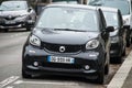 Front view of black smart car parked in the street