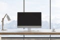 Front view on blank black modern computer monitor with space for your logo or text on wooden work surface table with white lamp on Royalty Free Stock Photo