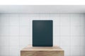 Front view on blank black modern digital tablet screen with space for web design, website or application on wooden stage in empty Royalty Free Stock Photo