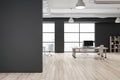Front view on blank dark wall in eco style spacious coworking office with city view from big windows, black walls and modern Royalty Free Stock Photo
