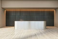 Front view on blank metallic stylish reception desk with place for your product presentation in stylish sunlit space with dark