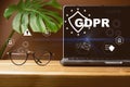 Front view of blank screen laptop, sign general data protection regulation GDPR and shield with key icon, eyeglasses