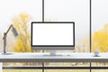 Front view on blank white modern computer monitor with space for your logo or text on light work surface with lamp and coffee mug Royalty Free Stock Photo