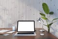 Front view on blank white modern laptop screen with empty space on brown wooden table with notebooks and coffee cup on light