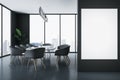 Front view on blank white poster on black wall in stylish sunlit meeting room with modern dark furniture and city view through Royalty Free Stock Photo