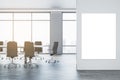 Front view of blank poster on light wall and empty modern conference room, with window, office desk and chairs on a Royalty Free Stock Photo