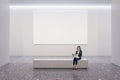 Front view on blank white poster with place for your logo on light wall background in spacious gallery hall with businesswoman Royalty Free Stock Photo