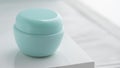 Front view of blue lotion container on white box with copy space
