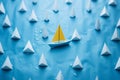 Front view of a blue paper boat amid a white armada