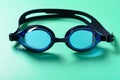 front view blue swimming goggles on green background Royalty Free Stock Photo