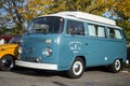 Front view of blue Volkswagen van parked in the street